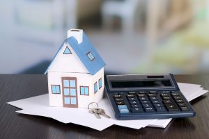 29546821 - toy house and calculator on table close-up